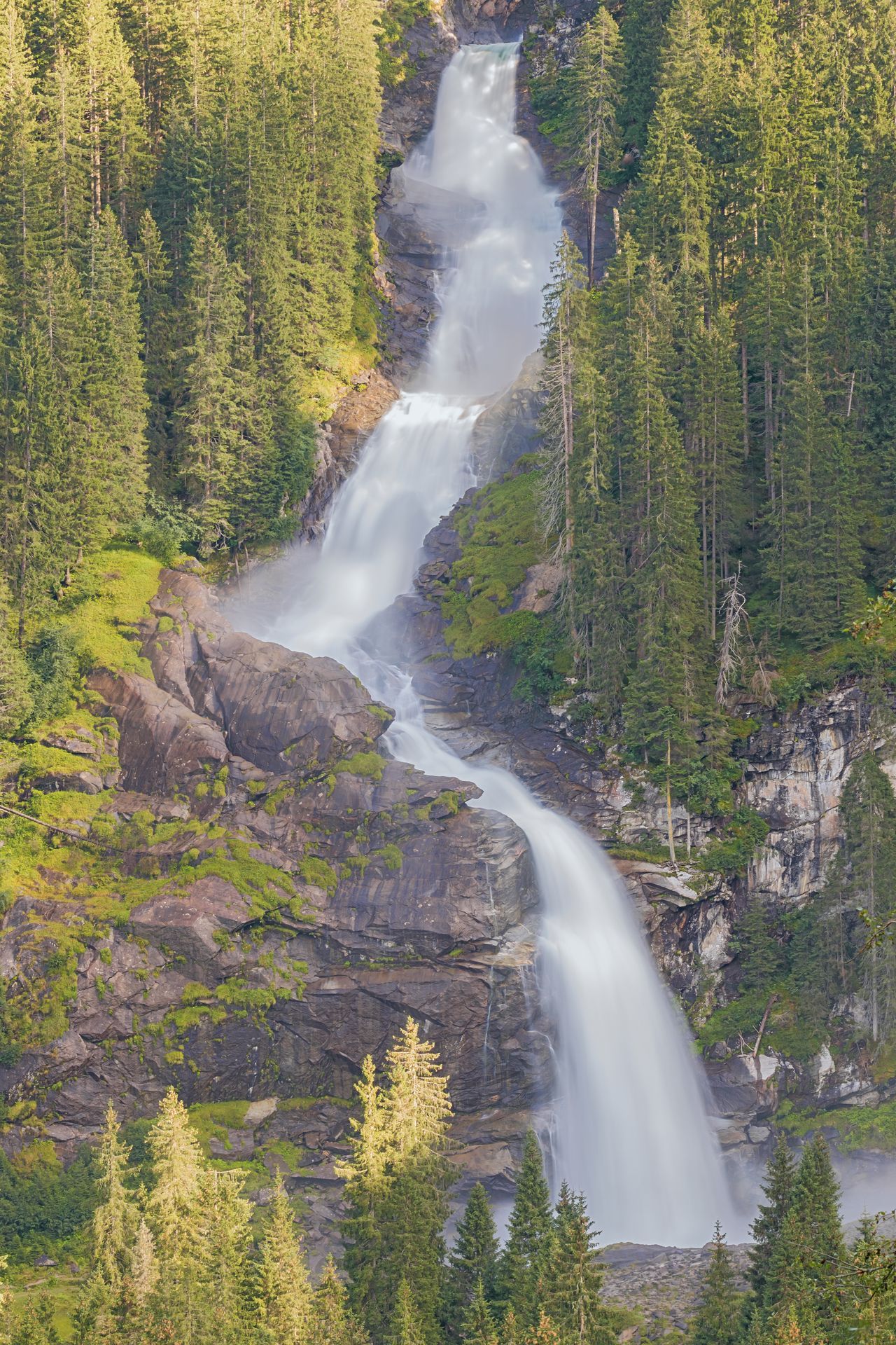 Long exposure close up through an opening in the forest of the Krimmler Waterfalls, seen from the Gerlos Pass