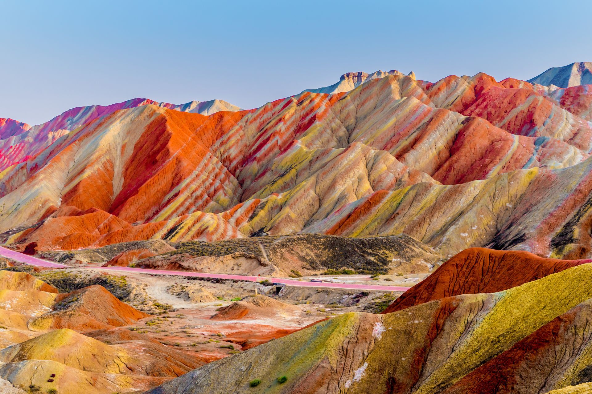 Amazing scenery of Rainbow mountain and blue sky background in sunset. Zhangye Danxia National Geopark, Gansu, China. Colorful landscape, rainbow hills, unusual colored rocks, sandstone erosion