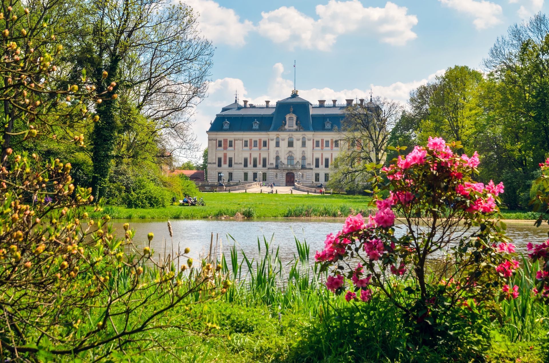 Beautiful historic castle in colorful spring scenery. Neo baroque castle in a park in Pszczyna in Poland.