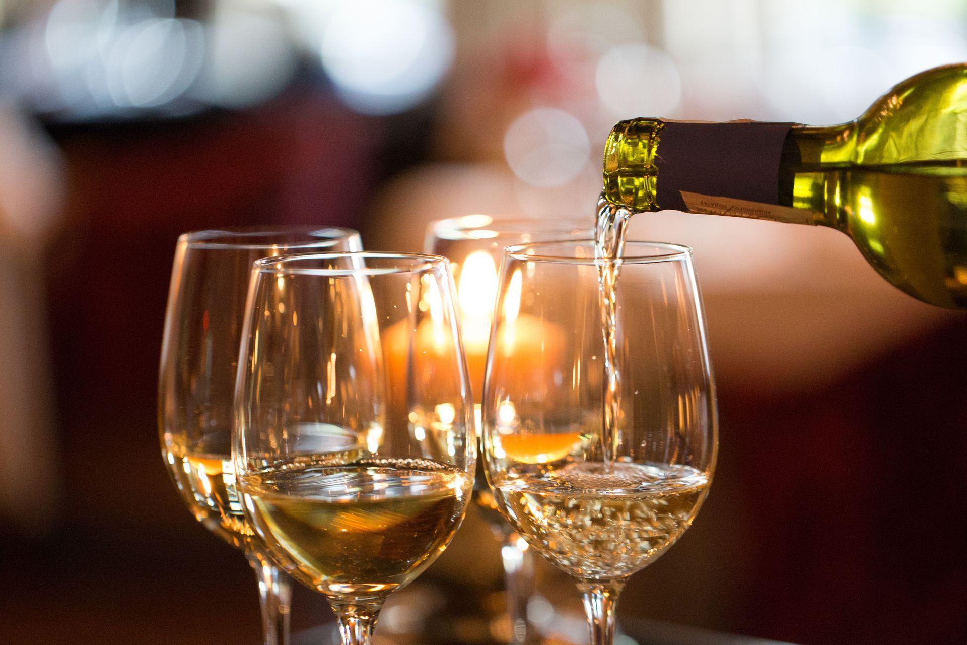 white wine pouring into a glass