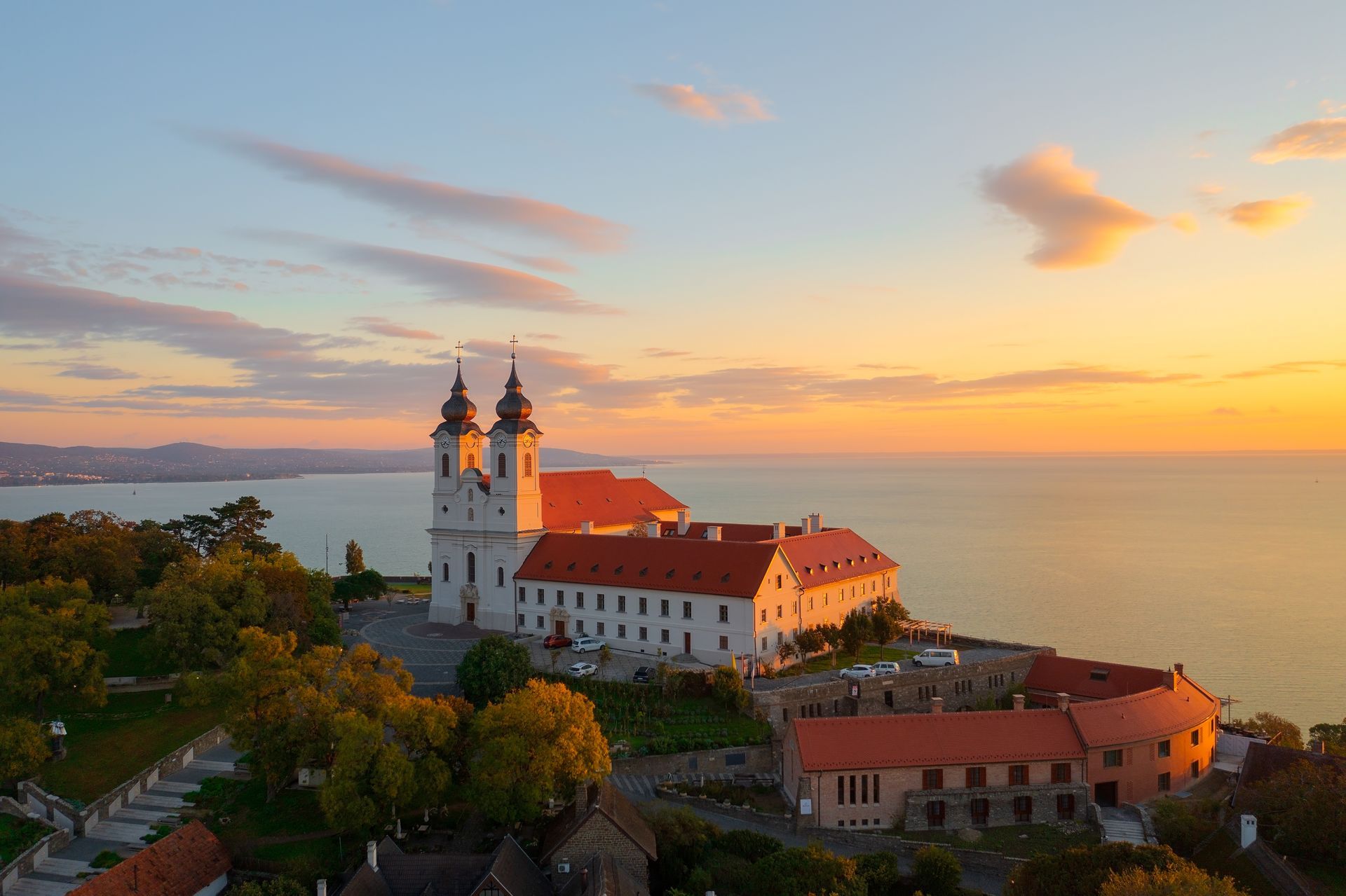 Tihany, Hungary - Aerial skyline view about the famous Benedictine Monastery of Tihany (Tihany Abbey) with beautiful colourful sky and clouds at sunrise.