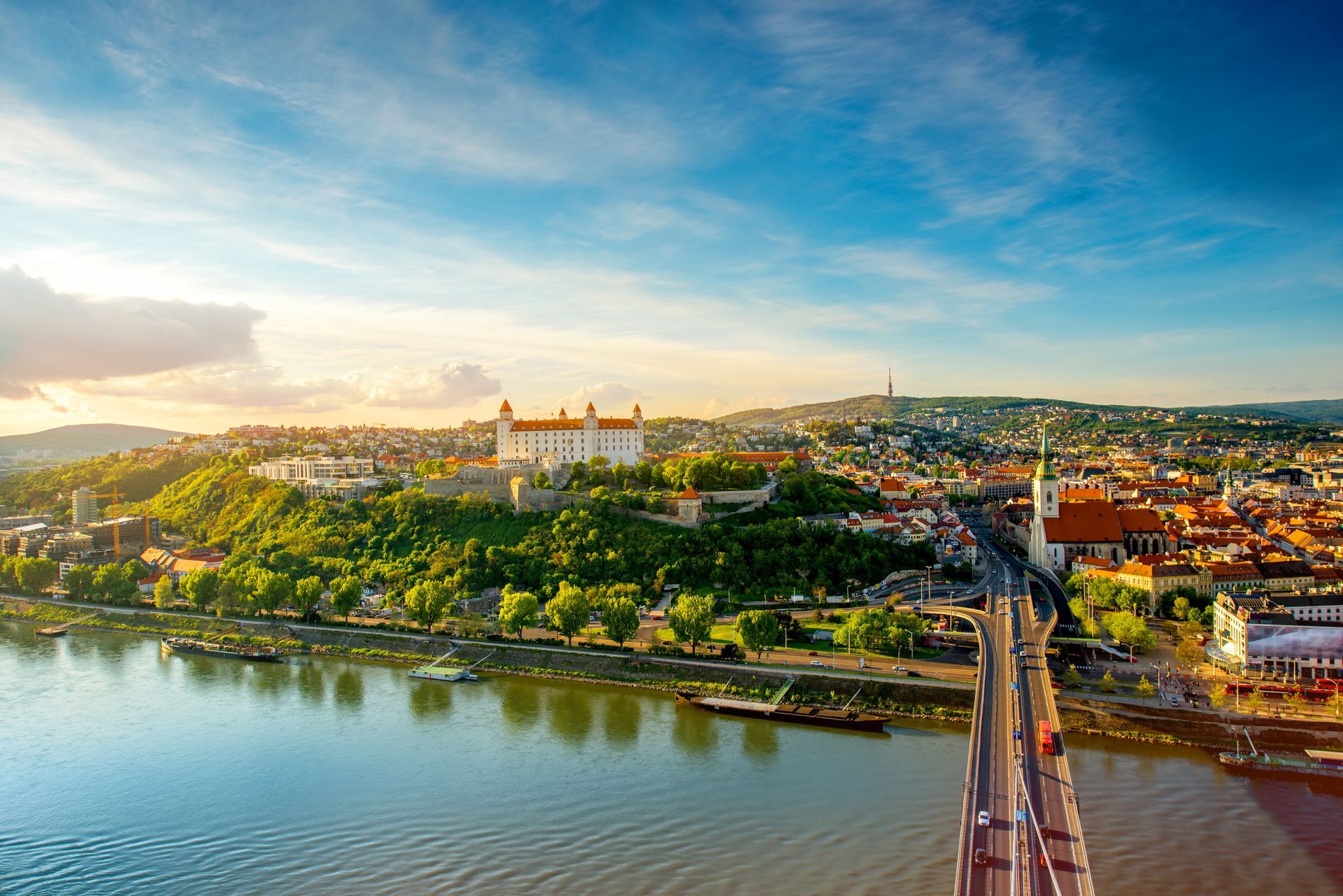 Bratislava aerial cityscape view on the old town with Saint Martin's cathedral, castle hill and Danube river on the sunset in Slovakia. Wide angle view with copy space