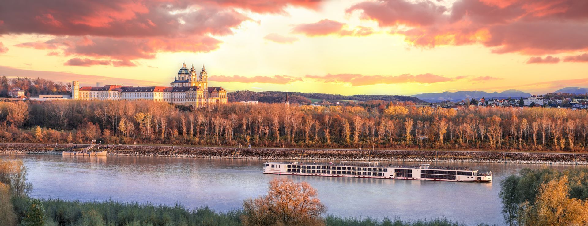 Panorama of Melk abbey with Danube river and autumn forest