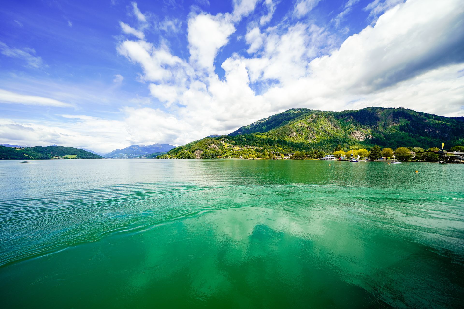 View of Lake Millstatt and the surrounding green landscape. Idyllic nature by the lake north of the Drava Valley near the town of Spittal an der Drau in Carinthia.
