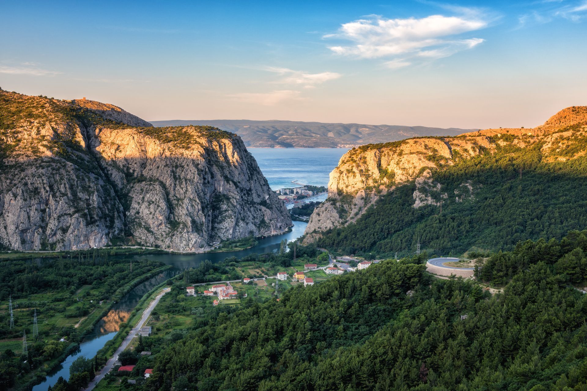 Panoramic view of the canyon and estuary (mouth) of Cetina river, town of Omis and island Brac in Adriatic sea through the rocky Dinara mountains, Croatia