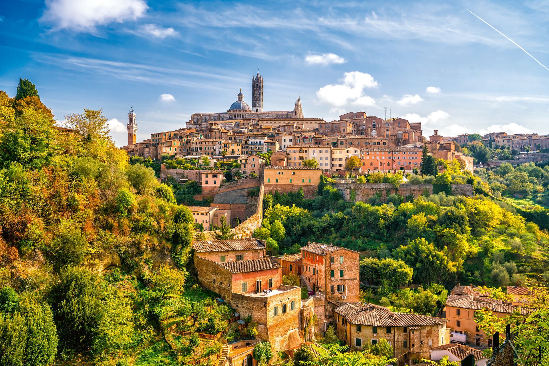Downtown Siena skyline in Italy with blue sky