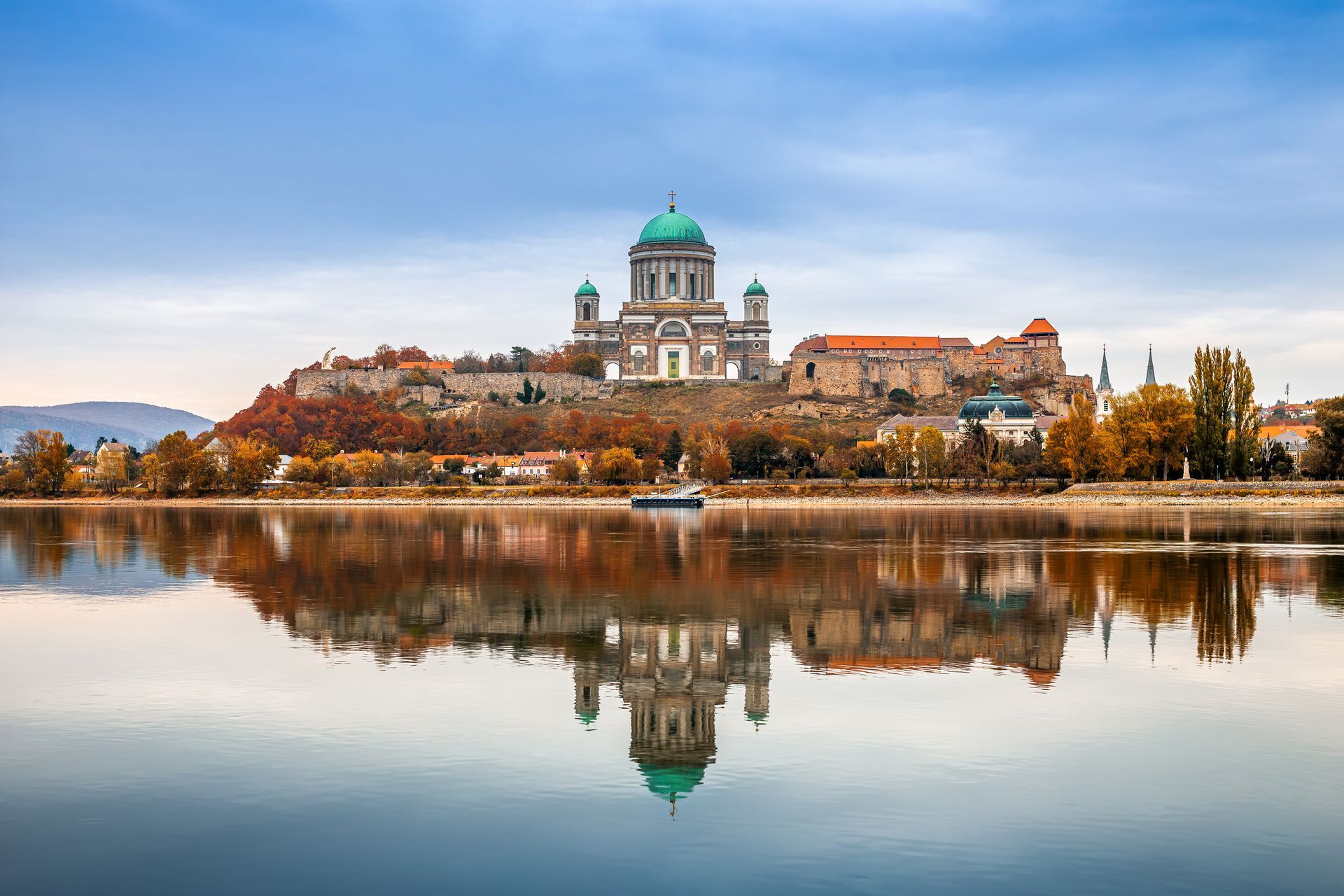 Esztergom, Hungary - Beautiful autumn morning with the Basilica of the Blessed Virgin Mary at Esztergom by the River Danube. Autumn colors and reflections of the Basilica are mirrored in water