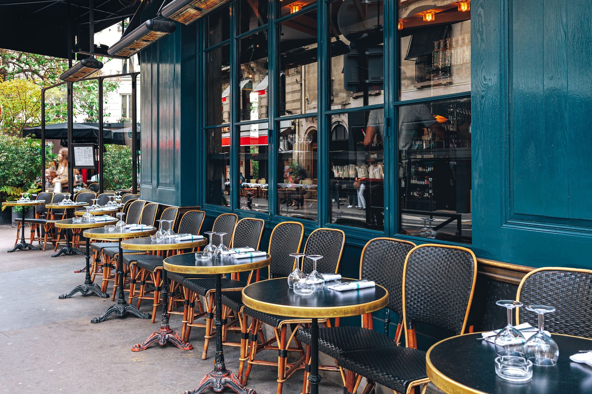 Tables and chairs in outdoor cafe in Paris, France.