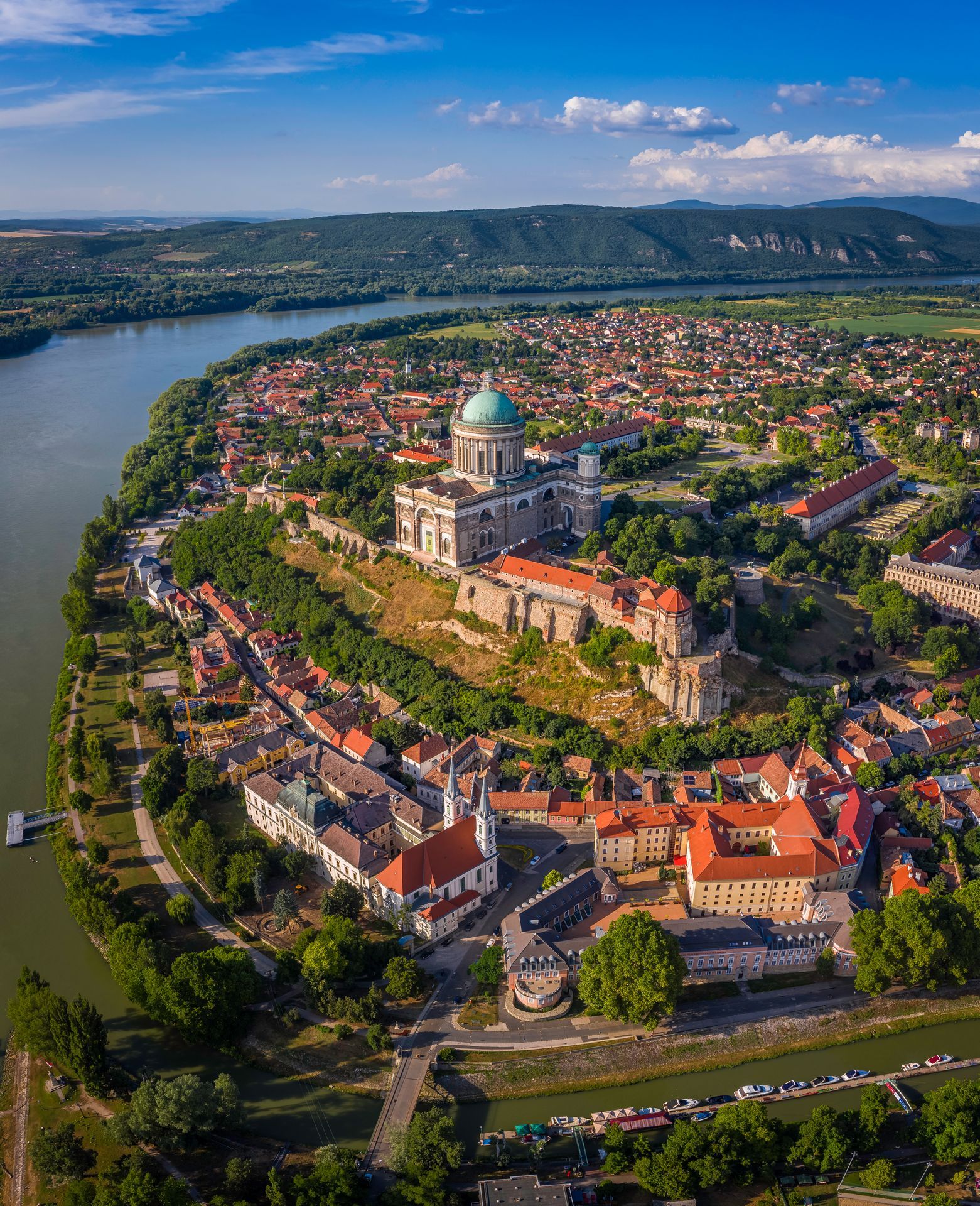 Esztergom, Hungary - Aerial panoramic view of Primatial Basilica of the Blessed Virgin Mary Assumed Into Heaven (Basilica of Esztergom) on a summer day with blue clouds and River Danube at background