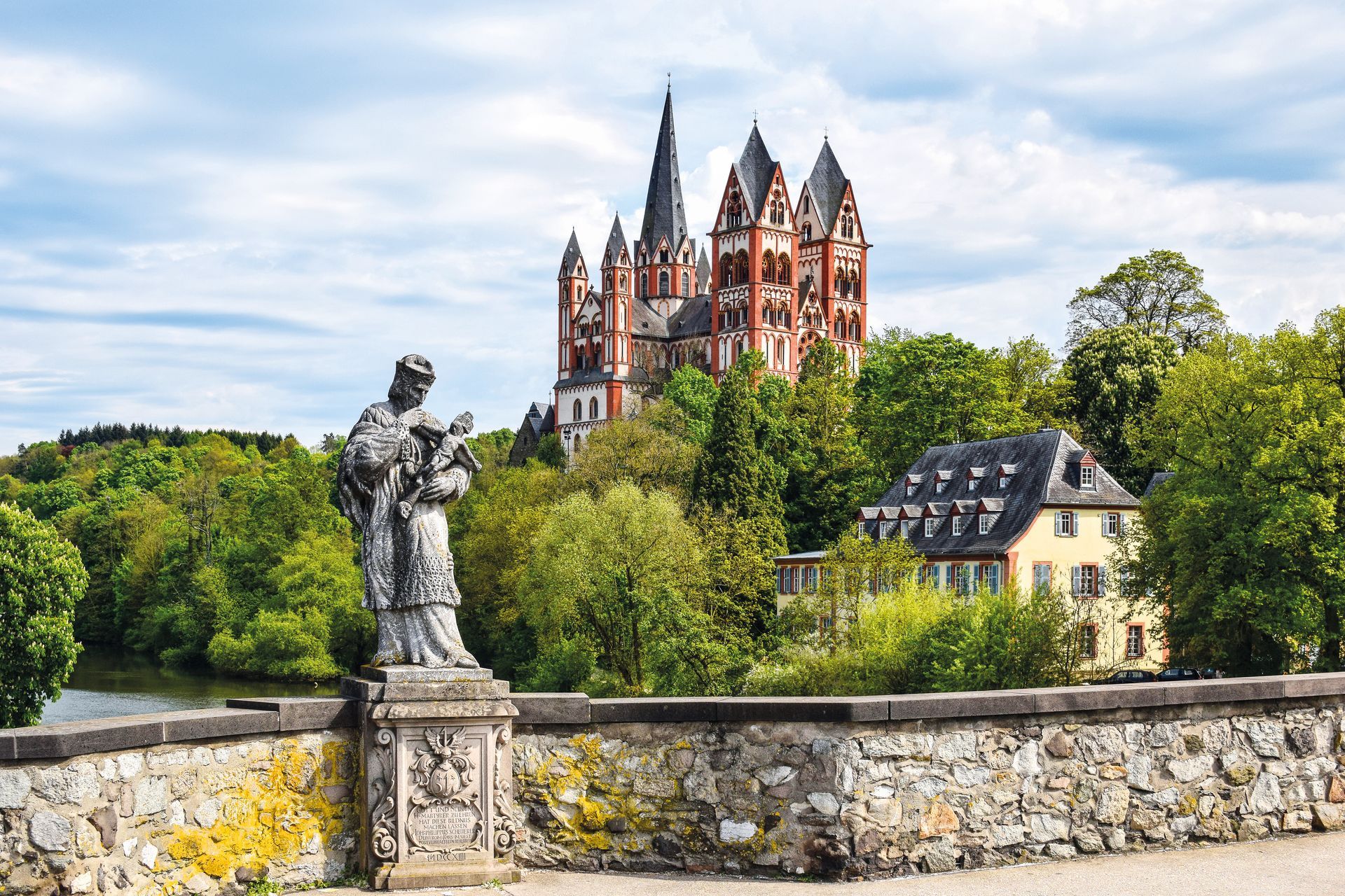 The Catholic Cathedral of Limburg at the river Lahn (German: Dom zu Limburg), Germany, viewed from the old Lahn bridge with a statue of Saint John of Nepomuk.